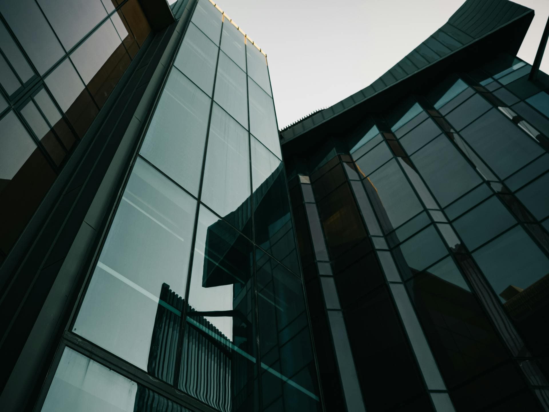 Low-angle view of towering modern glass and steel architecture